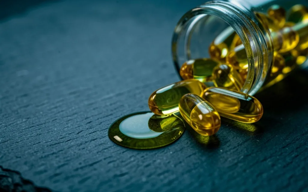 Fish oil capsules on a dark surface